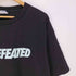 アンディフィーテッド UNDEFEATED フロントロゴプリント クルーネックTシャツ メンズ import:XL