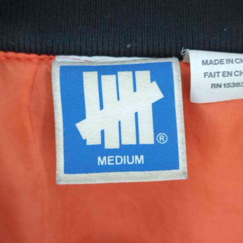 アンディフィーテッド UNDEFEATED バックフォトプリント 刺繍ロゴ リバーシブル フライトジャケット MA-1 メンズ import:M