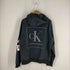 カルバンクラインジーンズ Calvin Klein Jeans ホログラムロゴプリントプルオーバーフーディー メンズ JPN:L