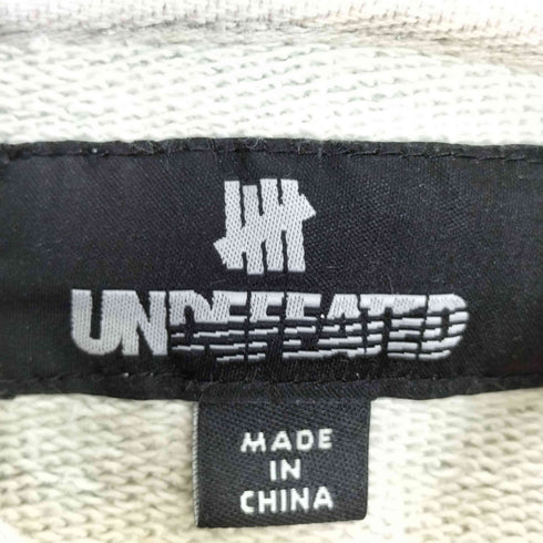アンディフィーテッド UNDEFEATED 総柄 U-MAN ジップアップパーカー メンズ L
