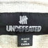 アンディフィーテッド UNDEFEATED 総柄 U-MAN ジップアップパーカー メンズ L