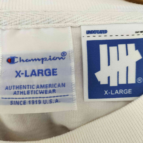 アンディフィーテッドチャンピオン UNDEFEATED CHAMPION 袖ロゴ刺繍クルーネックTシャツ メンズ JPN:XL
