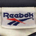 リーボック Reebok 90-00S 刺繍タグ 総柄 ジップアップナイロンジャケット メンズ