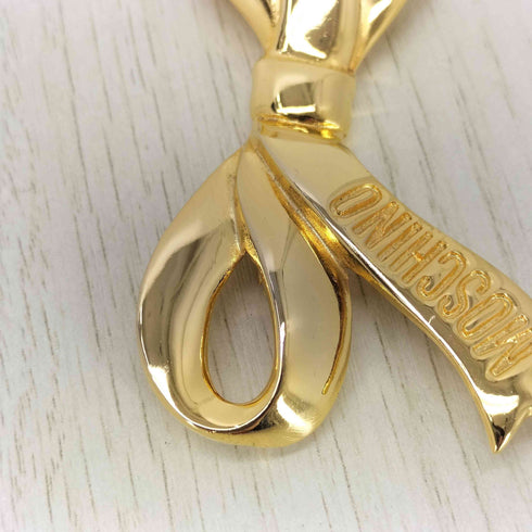 モスキーノ MOSCHINO ゴールドリボン ブローチ レディース